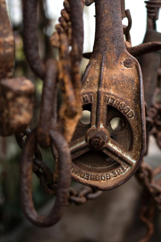 a rusty chain with a metal lock hanging from it