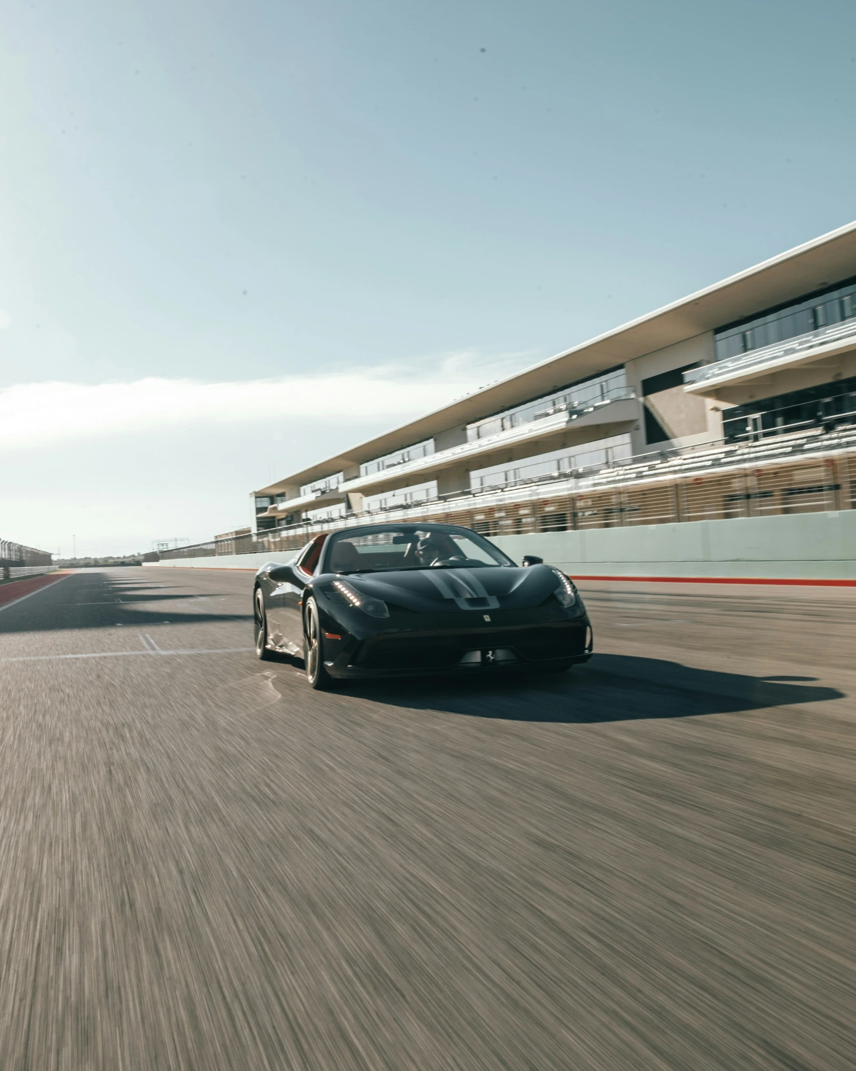 a silver sports car is driving in front of another one