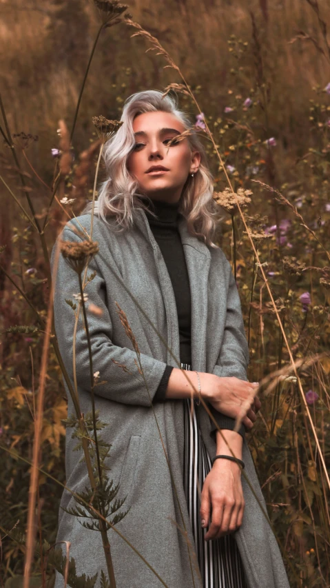 an image of woman standing by grass