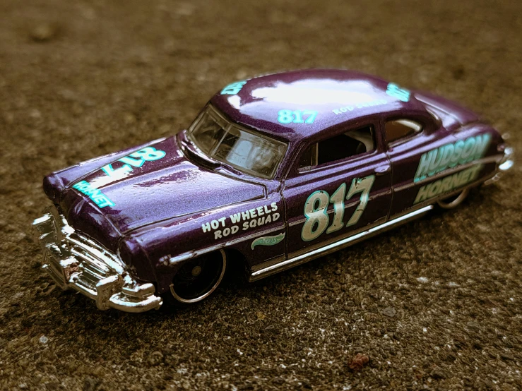 a purple toy car with number seventy on the front