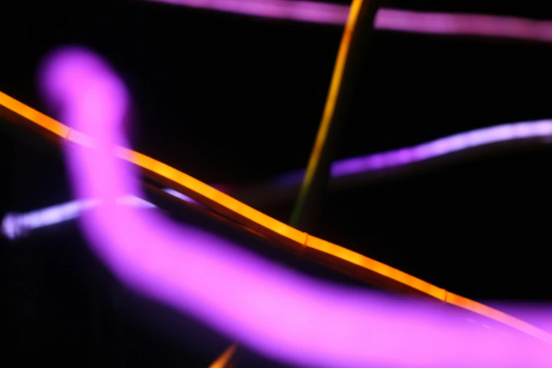 a closeup of an electric wire in the dark