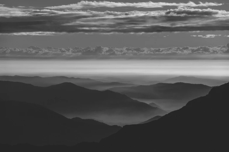 the view of mountains and clouds from a high hill