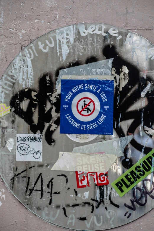 a round sign is covered in writing and signs