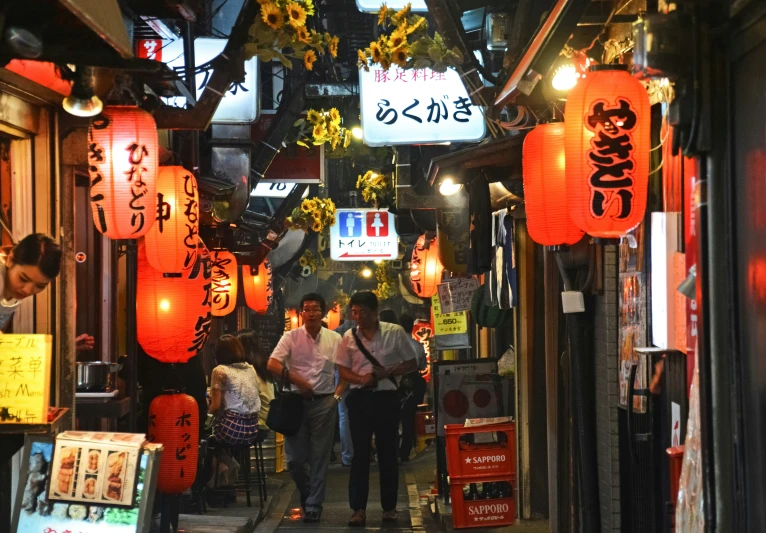 the narrow city alley is decorated with lanterns