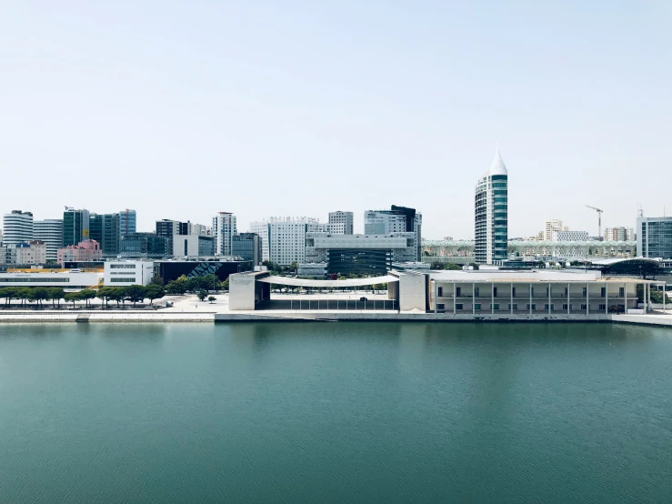 a water area with city buildings in the background