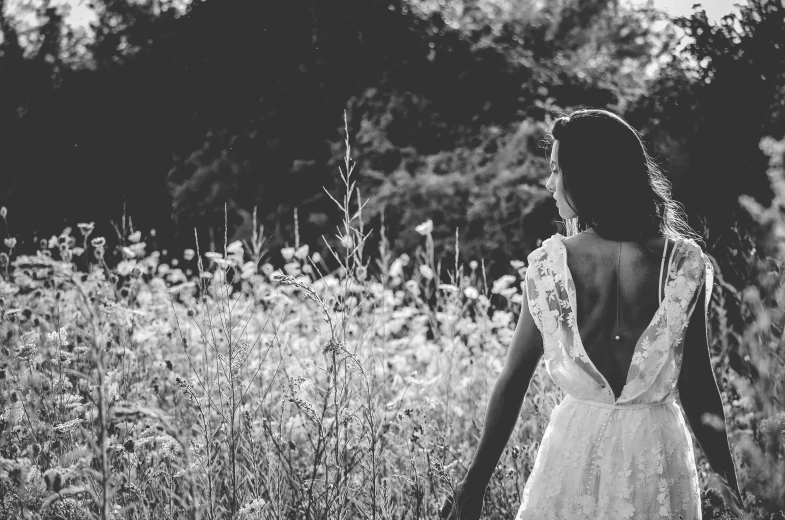 a girl in a white dress is standing in a field