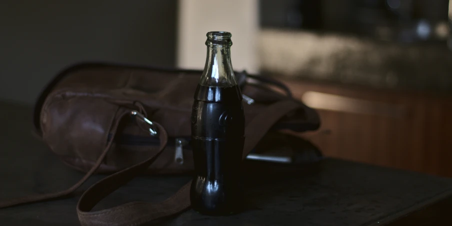 a bottle and a bag sitting on top of a table