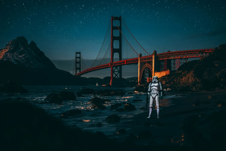 a man wearing an astronaut suit by the golden gate bridge