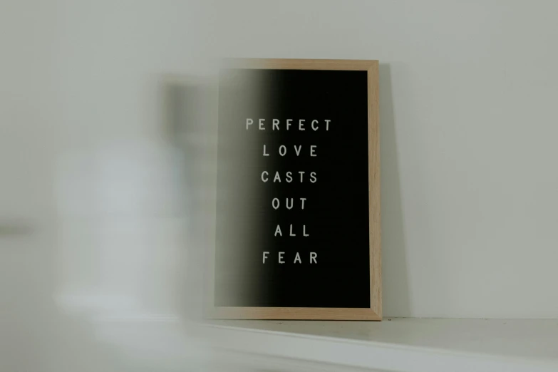 a sign on the wall that reads perfect love casts out all fear