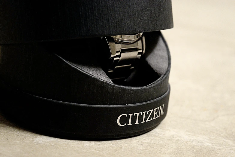 a watch and hat sits inside an unzipped hat