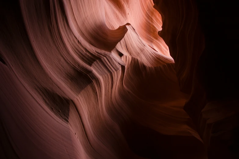 a very dark area shows a rock that looks like a face in the rock