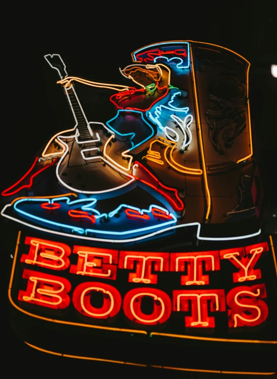 a neon sign with a guitar player on it
