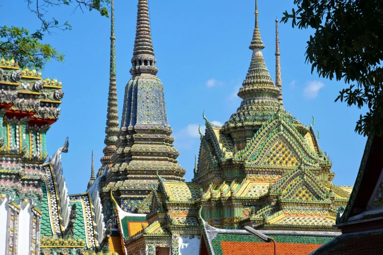 the spires of many buildings are designed in green and yellow