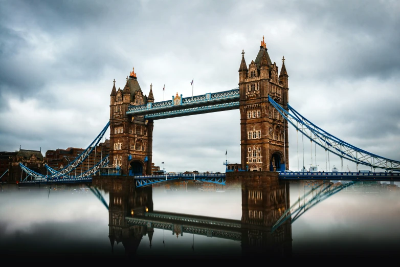 a long bridge is hanging over the water