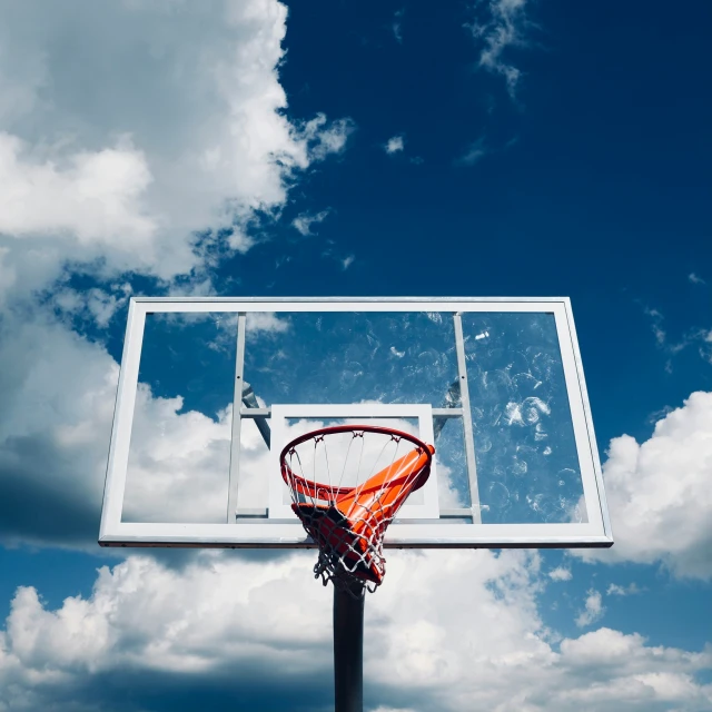 a basketball goal with an orange and white basketball inside