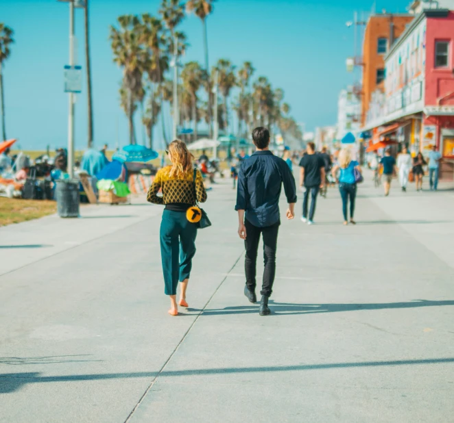 a man is walking with a woman down the sidewalk