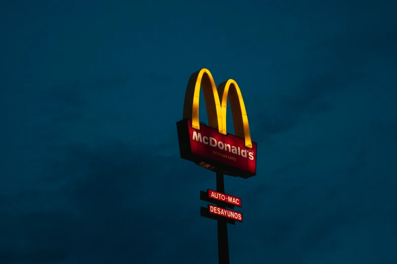 a large mcdonalds sign on top of a black pole