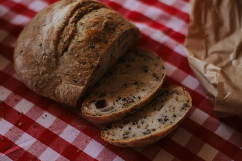 a loaf of bread on a red and white tablecloth