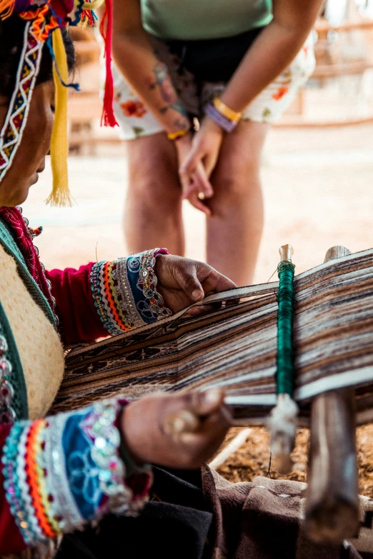 two women are weaving on a raft or raft