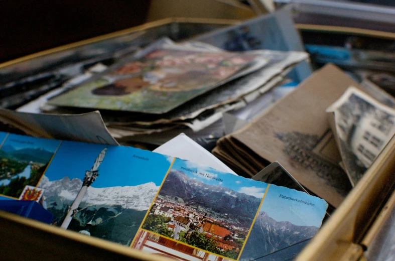 a brown box filled with lots of different sized pictures