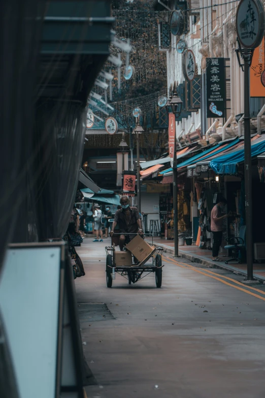 a woman and a man are riding an old cart on the side of a city street