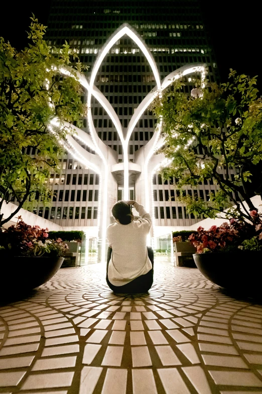 two people in front of an intricate building with lights