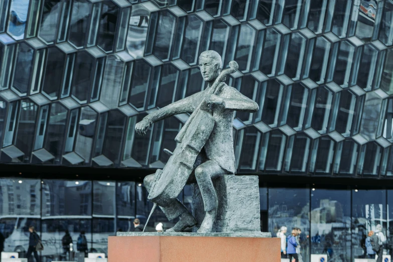 a statue of two people with a suit case and violin