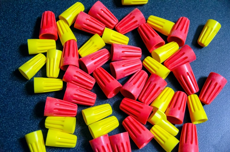 plastic pieces of yellow and red sitting on a table