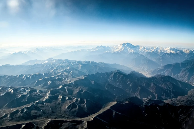 the mountains are looking down from an airplane