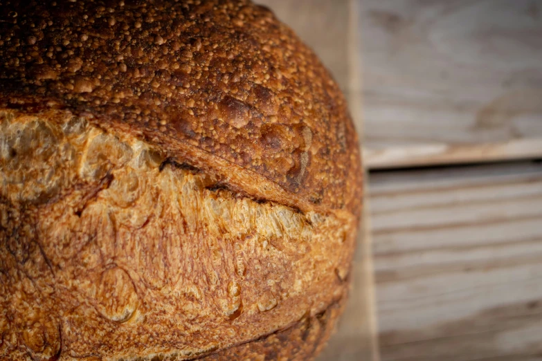 a loaf of bread in close up with the crust slightly smothered