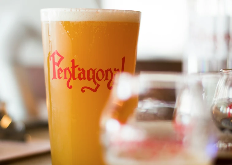 a full glass of beer sitting on top of a table