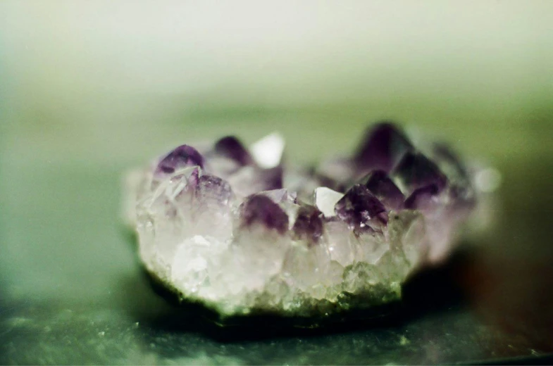 a purple and white crystals is seen on a table