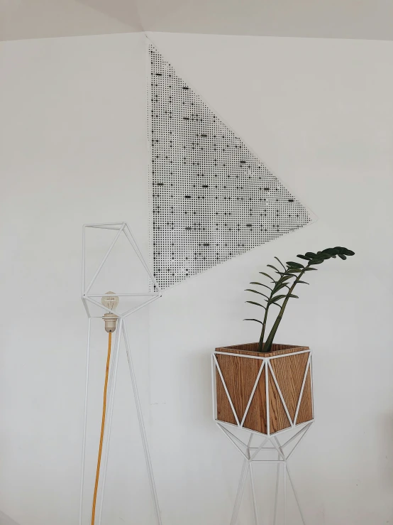 a white and wooden table with a plant on it