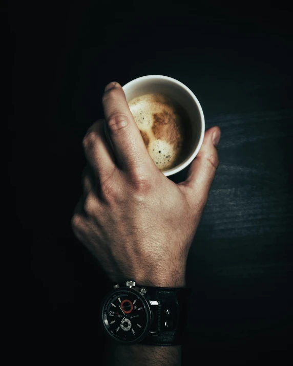 a person is holding up their coffee cup