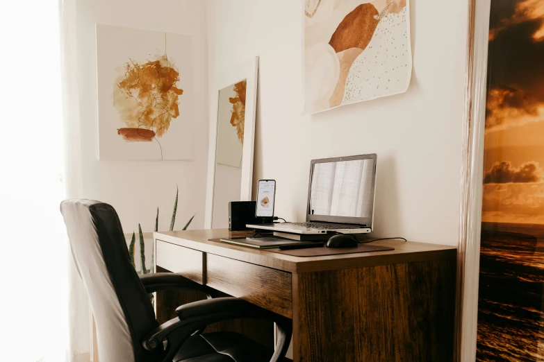 the chair sits at the computer desk beside the painting