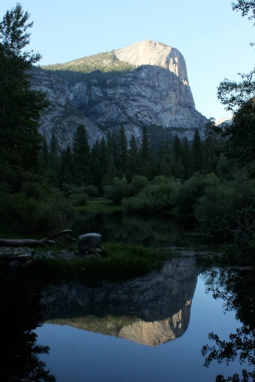 a reflection of a mountain in a lake