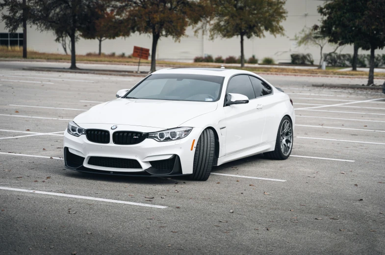 a white sports car parked in a parking lot