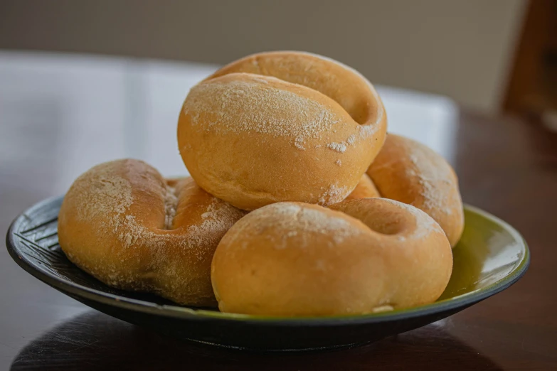 a bowl of donuts are piled on top of each other