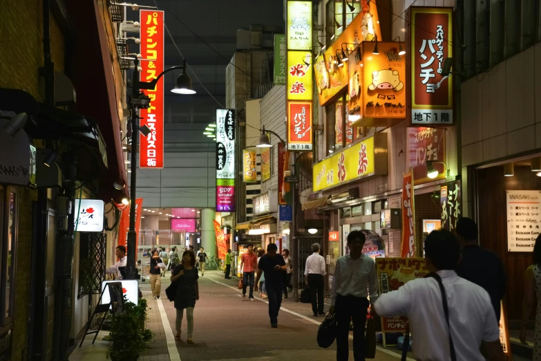 a group of people walk along an asian city street