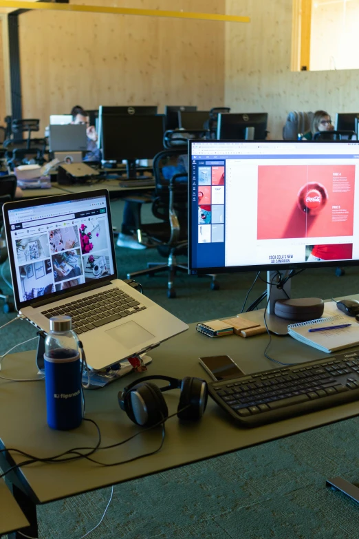 two monitors on the table with ear phones next to them