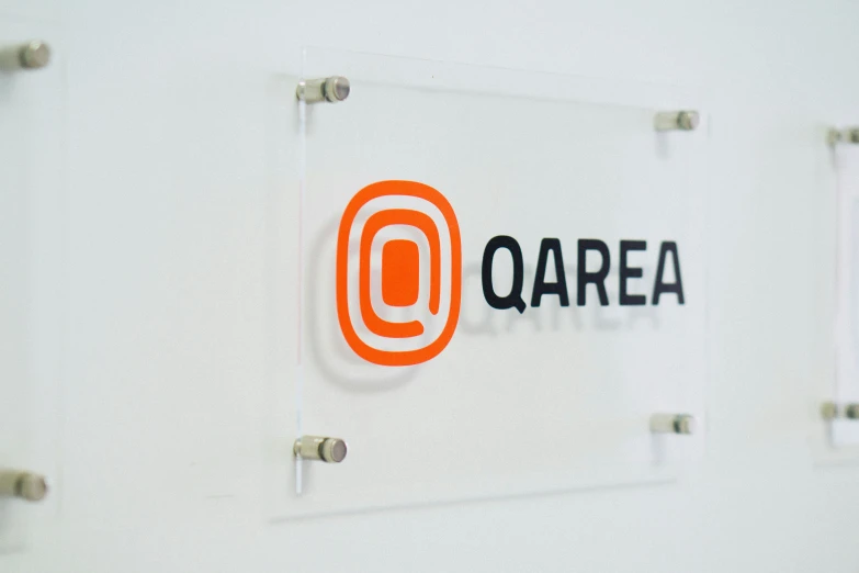 the logo for qurea is displayed on a wall