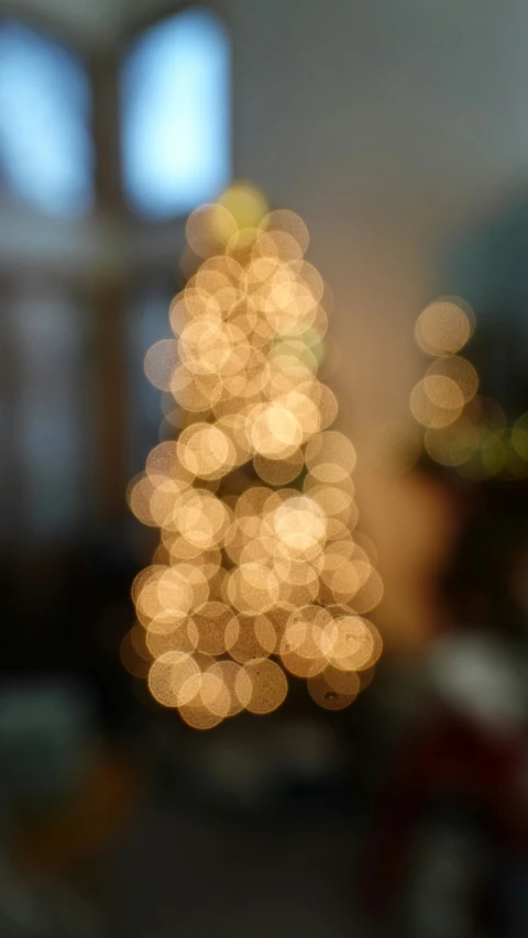 some lights shining on a christmas tree in a living room