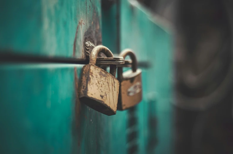 there is a padlock on the back of a green door