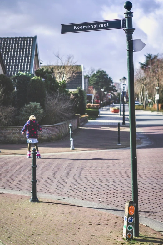 a young person on a pole by the street