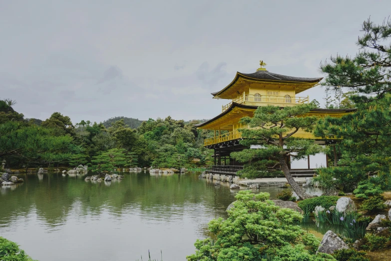 a very tall yellow building in a pretty landscape