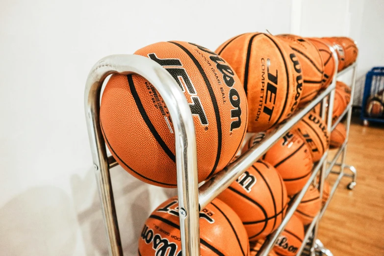 a rack with orange basketballs hanging up on it