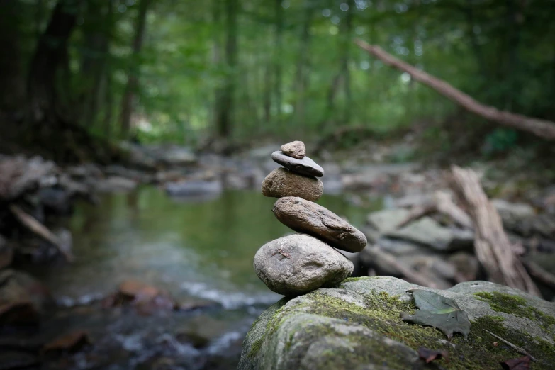 several rocks stacked in the middle of a stream