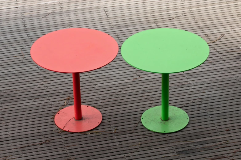 two small round tables are sitting on the ground