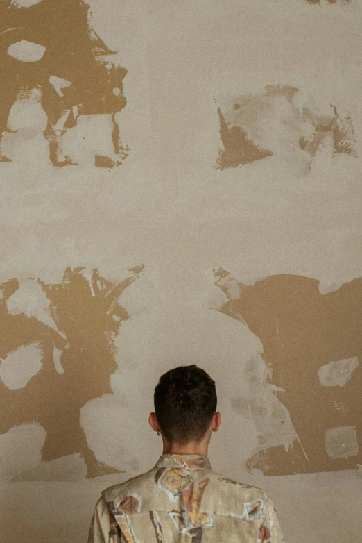 man in front of a wall with some paint
