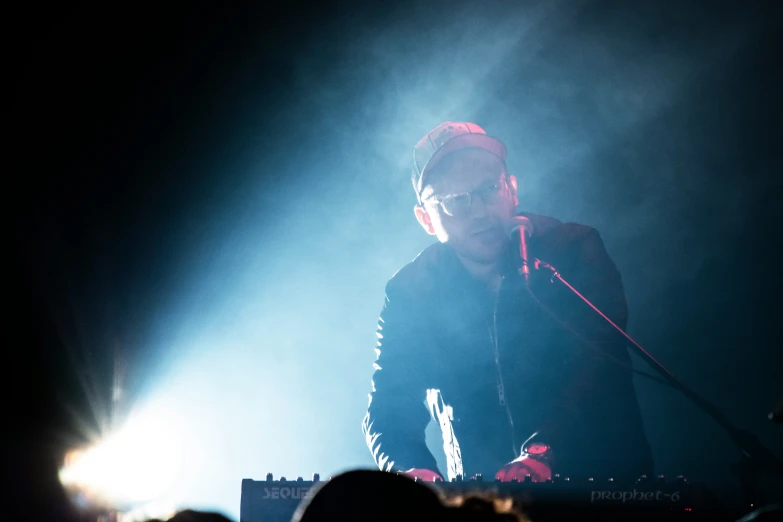 a person standing in front of a microphone at a concert